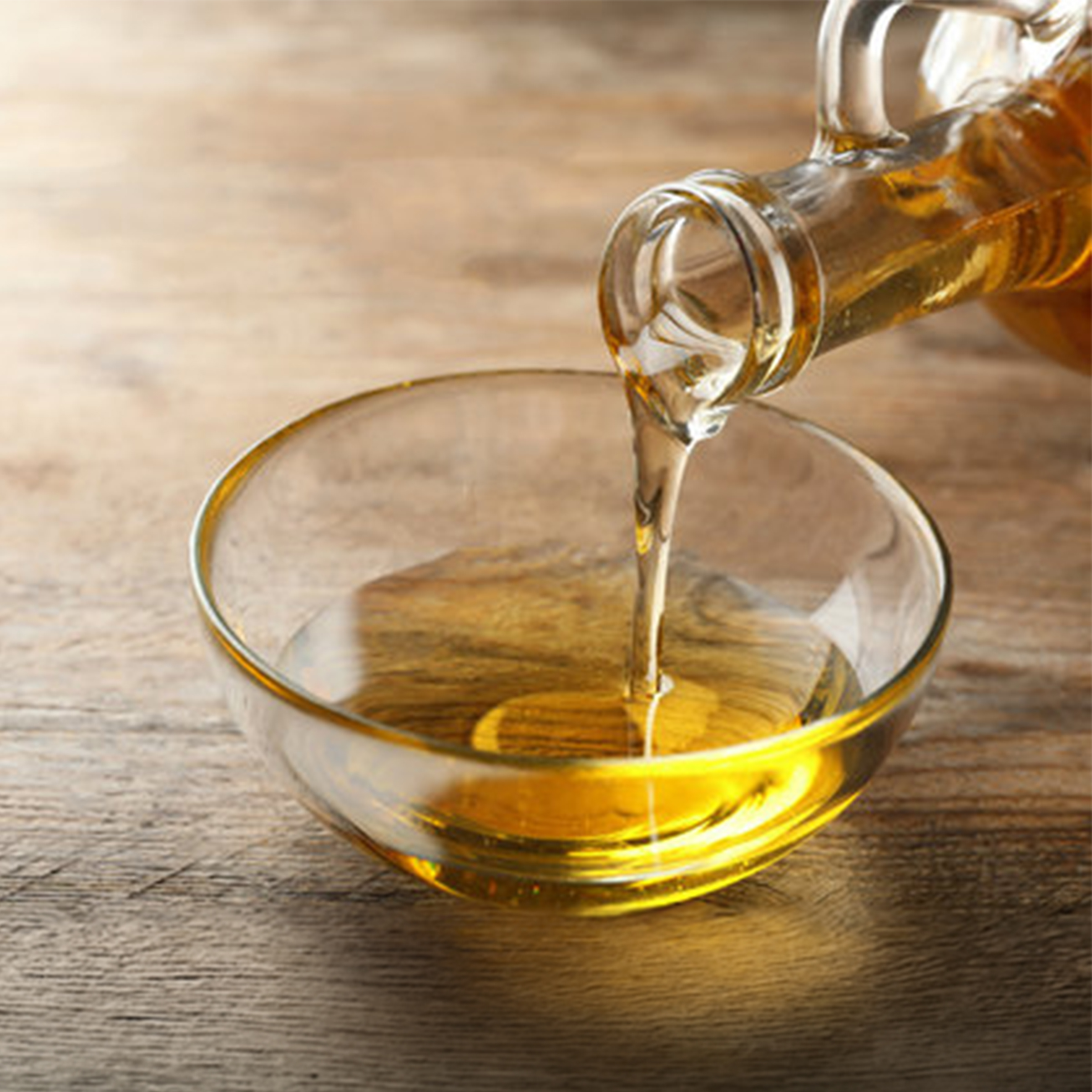 Golden oil poured into a glass bowl